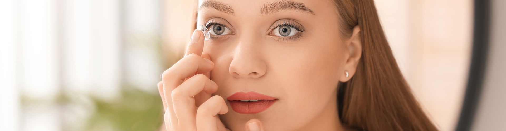 Patient putting in a contact lens
