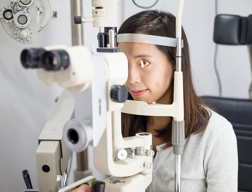 Optometrist performing a slit lamp eye exam